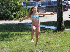 Maya Moreau, 9, cools off by running through a sprinkler in Sudbury, Ont. on Friday August 7, 2020. Environment Canada said Greater Sudbury can expect a mix of sun and cloud on Saturday with a high of 26 C.