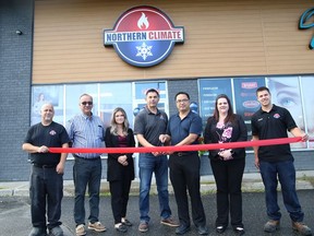 Northern Climate owners Brian Chretien and John Law, centre, and their employees, as well as city councillor Bill Leduc, second left, take part in a ribbon-cutting ceremony at the grand opening of the business at 1021 the Kingsway in Sudbury, Ont. on Tuesday August 11, 2020. Northern Climate caters to customers' heating, cooling and fireplace needs.