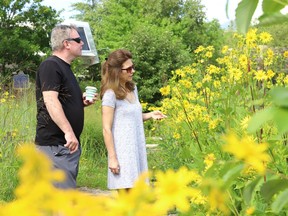 Monique Mallette and Mike Corbett admire the flowers and vegetation on the shoreline of Ramsey Lake at Science North in Sudbury, Ont. on Monday August 17, 2020.