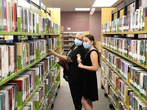 Carole Sanche and her granddaughter, Hope Newell, 10, search for books at the main branch of the Greater Sudbury Public Library on Mackenzie Street in Sudbury, Ont. on Monday August 17, 2020. All library branches will be open by next week.