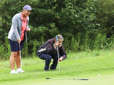 Pauline Therrien, right, lines up a putt on the tenth green as Sharon O'Brien looks on during play at Timberwolf Golf Club's ladies' open two person scramble in Sudbury, Ont. on Tuesday August 18, 2020. The one-day tournament featured 21 teams. John Lappa/Sudbury Star/Postmedia Network