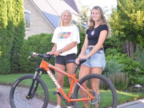 Friends Meredith Kusnierczyk, left, and Fiona Symington have each had a bicycle stolen this summer. The one they are posing with was also stolen but luckily police were able to recover it. Two others taken from the Symington home near Lake Nepahwin have still not been retrieved. Jim Moodie/Sudbury Star