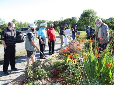 A group of volunteers tend to a garden at St. Stanislaus Cemetery near Lively, Ont. on Wednesday August 19, 2020. A sign dedication ceremony was held the same day. The City of Greater Sudbury erected the sign to recognize the many years of work done at the cemetery by volunteers and friends of Knights of Columbus Council 3909. Council 3909 transformed the land into 'a place of tranquility' by adding 12 gardens, planting more than 60 trees, adding a gazebo and installing a large sign at the cemetery entrance identifying St. Stanislaus Cemetery. A group of volunteers and friends of the Knights of Columbus maintain the gardens. The cemetery was relocated from Cinottiville, a former village located in the northeast corner of Waters Township on what was then Highway 17 West just past the Copper Refinery, to the current location donated by Inco Ltd. in 1970. John Lappa/Sudbury Star/Postmedia Network