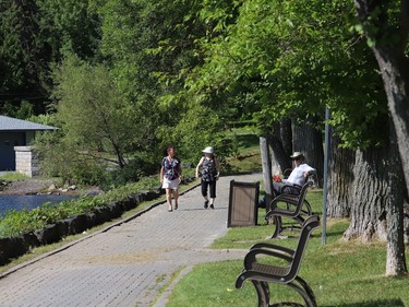 Two women stroll by Ramsey Lake in Sudbury, Ont. on Wednesday August 19, 2020. Environment Canada said Greater Sudbury can expect mainly cloudy skies with a 30 per cent chance of showers and a possible thunderstorm Thursday. The high is expected to reach 20 C. John Lappa/Sudbury Star/Postmedia Network