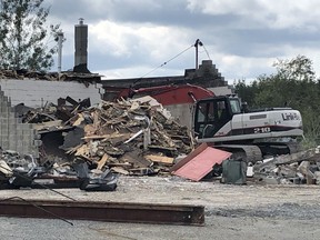 An excavator tears away at the Mr. Gas station and restaurant on Highway 17 in Wahnapitae Friday afternoon. The site has been idle for some time. HAROLD CARMICHAEL/SUDBURY STAR