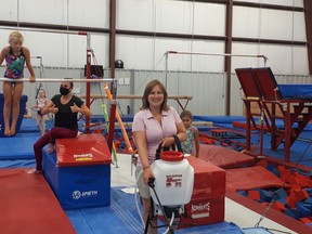 The Bluewater Gymnastics team uses its specialized cleaning machines to sanitize the club. From left are Erica Verberne, Olivia Vansevenant (on bars), coach Pilar Maldonado, executive director Rose-Ann Nathan, recreation director Taylor Murray.Handout/Sarnia This Week