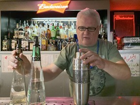 The Victory Tavern's current owner and operator Randy Gattesco stands behind the bar while preparing shots for willing customers. The tavern is celebrating its 90th birthday this year. Gattesco has owned The Vic since 1999.

Elena De Luigi/The Daily Press