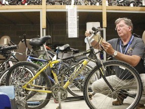 Marc Depatie, corporate communications coordinator with the Timmins Police Service, displays some of the unclaimed items in storage that will go under the hammer during the annual TPS auction being held this Saturday. 

RICHA BHOSALE/The Daily Press