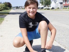 Riley-Joel Browne, a 12-year-old from Timmins, laces up his now well-worn sneakers after running 100 kilometres throughout the month of May and, in the process, raising $2,550 for a charitable organization that fundraises for multiple sclerosis research. 

RICHA BHOSALE/The Daily Press