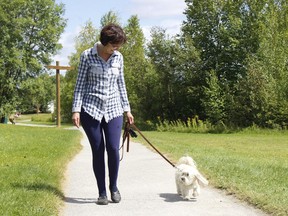 Lilianne Richer took advantage of the sunshine and warm weather on Wednesday to walk her dog, Kami, at Gillies Lake.

RICHA BHOSALE/The Daily Press