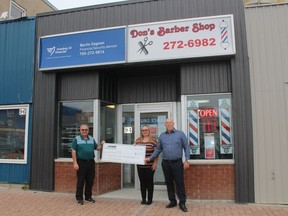 A cheque from the Cochrane Improvement Plan is presented to Nathalie and Bertin Gagnon by Mayor Denis Clement for their work at helping to give 6th Avenue a facelift. .TP.JPG
