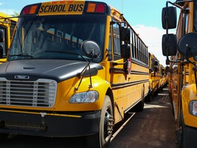 School buses parked outside Holy Trinity High School in Fort McMurray on Tuesday, July 28, 2020. Sarah Williscraft/Fort McMurray Today/Postmedia Network