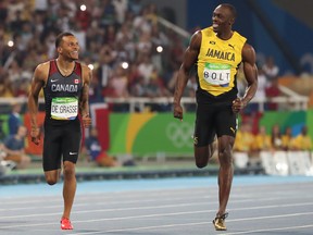 Andre de Grasse (left) of Canada and Usain Bolt of Jamaica run in the men's 200m semifinal at the Rio 2016 Olympics.