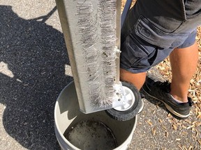 An employee of the city of Woodstock shows sewing needles and thumb tacks found Aug. 19 near playground equipment at Southside Park. (SUBMITTED PHOTO)