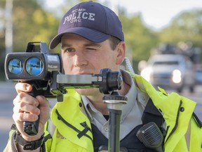 RCMP Corporal Jeffery Dunbar checks the speed of vehicles coming through the 100 Street school zone in front of Swanavon School on Tuesday, Sept. 1, 2020. Motorists are reminded with students being back in school that school zone speed limits of 30 km/h are back in effect.