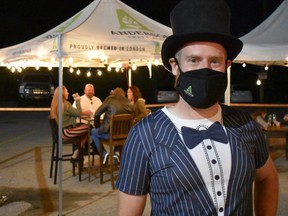 Brewmaster Gavin Anderson adds a formal touch greeting diners at outdoor tables during Anderson Craft Ale's fourth birthday party on Aug. 29. The usual beer festival marking Anderson's annual milestone couldn't happen because of the pandemic, so it was revamped as a four-course sit-down meal by EatOA and an open bar featuring more than 25 beers and craft sodas by Anderson, fellow London brewers, as well as out-of-towners. (Barbara Taylor/The London Free Press)