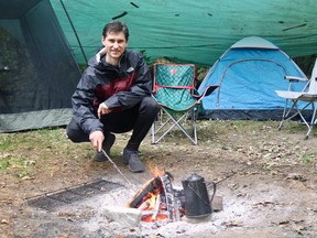 The rainy Labour Day weekend weather didn't dampen Sebastian Voth's camping experience at Brant Park as he came equipped with a giant tarp to cover his entire setup. (ASHLEY TAYLOR)