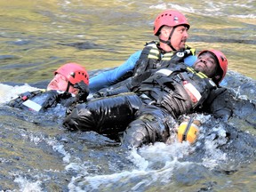 Warrant Officer Nick Luhtanen, a member of the 3rd Canadian Ranger Patrol Group, holds a pair of victims, while waiting for others soldier to come to his aid during a swift-water rescue exercise at Cody Rapids on the Magnetawan River, north of Parry Sound recently. Luhtanen and other instructors will be providing training to residents of First Nation communities across Northern Ontario as part of the Canadian Rangers program. SGT. PETER MOON/ FOR THE DAILY PRESS