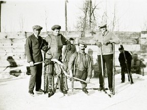 77.897.009  Hockey in the early years was played on an open-air rink adjacent to what is now the Alberta Treasury Branch at 99 Street and 100 Avenue. It attracted hockey players, such as those pictured: (l-r) Cecil Tretick, holding up goal  goalie Eldon McLure, and Ralph Hutchison. Sidney Shorty Sweeney commands the centre of the photograph. However, rather than standing still as he is here, he was usually seen as he whizzed around the rink, a gutsy performance on the ice  a skate on his left foot, a stick with a nail in the end under his right arm, and a hockey stick in his left hand.