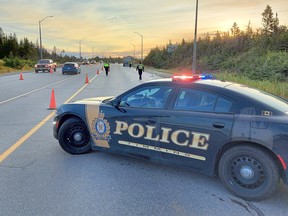 A Timmins Police Service cruiser blocks off the flow of traffic on Highway 101, just east of Schumacher, Tuesday morning. A collision between a tractor an east-bound trailer unit and an east-bound cyclist resulted in the death of a 59-year-old Schumacher resident. TIMMINS POLICE SERVICE PHOTO