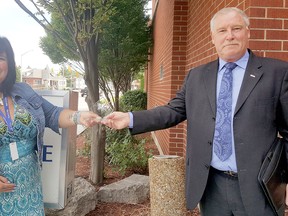 Kristine Jarvis, a civilian employee with the Chatham-Kent Police Service, was recognized as a community role model outside headquarters on Sept. 2. Also shown is Bruce Chapman, president of the Police Association of Ontario. Trevor Terfloth/Postmedia Network