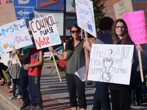 More than 50 people came out to protest mandatory masks in front of city hall in Grande Prairie, Alta. on Tuesday, Sept. 8, 2020.