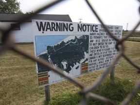 A sign pictured in 2015 warns visitors to the former army camp at the Chippewas of Kettle and Stony Point First Nation of unexploded ordnance in parts of the 971-hectare site. It's estimated it'll take another 25 years to clear, a Department of National Defence spokesperson says. (Postmedia file photo)