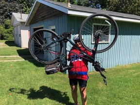 Henrietta Mulder, 72, raised more than $10,000 and biked more than 500 kilometres in support of SickKids Hospital in August. An overhead bike lift is tradition at the completion of a ride, and Mulder said she's already planning for next year's challenge. (Courtesy of Henrietta Mulder)