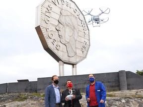 Science communicator Alexandre Slaney, right, gives Sudbury MP Paul Lefebvre, left, and Nickel Belt MP Marc Serre instructions on how to fly a drone at a $1.4 million funding announcement at Dynamic Earth in Sudbury, Ont. on Thursday September 10, 2020.