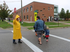 Crossing guard Albert Wood was back at his post Thursday as classes began at P.E. McGibbon public school in Sarnia. It was the first day of staggered returns to local classes for the new school year.