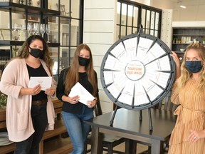 The Perth County Tourism Travelling Deal Wheel was at Millbank Family Furniture all day Friday. Pictured from left are Millbank Family Furniture employees Marianna Streicher and Melanie Menkveld, and Perth County tourism officer Ashley Brockelbank. (Galen Simmons/The Beacon Herald)