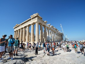 Tourists visit the Parthenon temple on the Acropolis hill, in downtown Athens. Greece was one of the destinations for Sunshine Travel Club in 2020. AFP/GETTY IMAGES