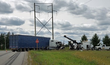 A tow truck vehicle works to lift the front end of a transport truck that was involved in a two-vehicle collision in Zorra Township on Monday September 14, 2020. The collision took place at the intersection of the 17th Line and Road 64 southeast of Thamesford. Police said one person was taken to the hospital with minor injuries. Greg Colgan/Woodstock Sentinel-Review/Postmedia Network