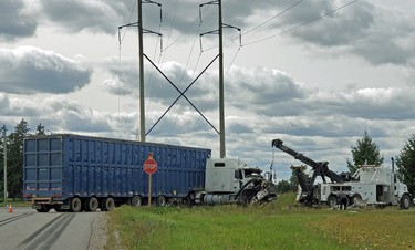 A tow truck vehicle works to lift the front end of a transport truck that was involved in a two-vehicle collision in Zorra Township on Monday September 14, 2020. The collision took place at the intersection of the 17th Line and Road 64 southeast of Thamesford. Police said one person was taken to the hospital with minor injuries. Greg Colgan/Woodstock Sentinel-Review/Postmedia Network