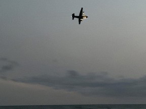 A Hercules search and rescue plane flies over Sauble Beach at sunset during a search for a swimmer missing off Saugeen First Nation Sunday night.