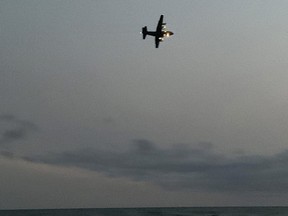 A Hercules search and rescue plane flies over Sauble Beach at sunset during a search for a swimmer missing off Saugeen First Nation Sunday night.