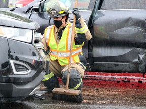 Firefighters clean up following a three-vehicle collision on Northern Avenue, west of Great Northern Road, on Saturday, Sept. 12, 2020 in Sault Ste. Marie, Ont. (BRIAN KELLY/THE SAULT STAR/POSTMEDIA NETWORK)