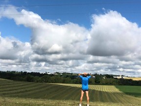 Pete Meades, near Lucknow, Ont., takes a break on his 3,000 km run across Huron County. He's running every road, picking up trash along the way. (Pete Meades)