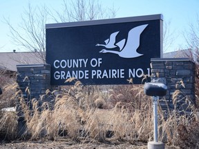 A sign outside the County of Grande Prairie administration office in Clairmont, Alta. Saturday, April 18, 2020.