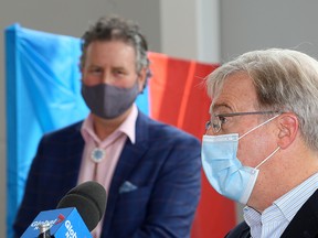 Mark Green, left, provost and vice-principal academic at Queen's University, and Dr. David Pichora, president and CEO of the Kingston Health Sciences Centre, announce the opening of a satellite COVID-19 Assessment Centre inside Mitchell Hall on Tuesday. (Ian MacAlpine/The Whig-Standard)