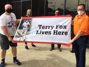 Chatham Terry Fox Run organizer Pat McMahon (left), general manager of corporate services and chief human resources officer Cathy Hoffman, chief administrative officer Don Shropshire and Mayor Darrin Canniff raise the Terry Fox Run flag at the Chatham-Kent Civic Centre on Monday. Submitted