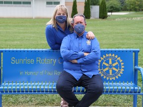 Susan Bechard, left, and her husband Ken, the president of Rotary Club of Chatham Sunrise, are shown wearing masks at a park bench. They are among the Chatham-Kent residents featured in a music video released by the club to encourage people to follow COVID-19 safety measures. (Handout/Postmedia Network)