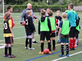 Sarnia FC Club President Adam Lakey, in grey, fourth from left, speaks to players during the club’s Return to Soccer session. (Carl Hnatyshyn/Postmedia Network)