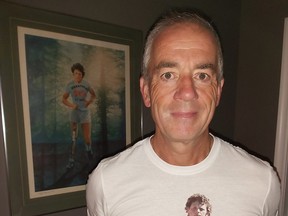 Brad Eggett, one of the Wallaceburg Terry Fox Run organizers, models the $20 shirt that is available at New Vision Optical in Wallaceburg, with the shirts' proceeds going toward the run fundraiser. (Handout/Postmedia Network)