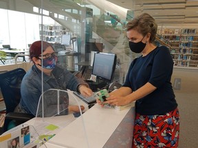 The Grande Prairie Public Library has resources to support parents and their child through the academic year. L-R: Hailey McCullough, head of adult services, helps out Library Director Deb Cryderman. GPPL