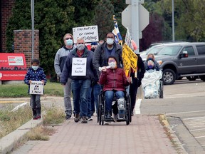 Activists marched to Spruce Grove-Stony Plain UCP MLA Searle Turton's office Saturday in Spruce Grove to protest a number of actions Premier Jason Kenney's government has taken since being elected. This is the third protest at the space.