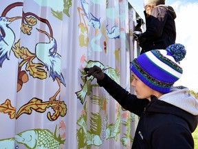 Local artist Laura Peturson works on a mural at the Family of Rotary’s Splash Pad. Supplied photo