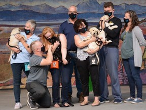 Dogs with Wings paired four puppies to local foster families during the Puppy Pick Up Parade at the Muskoseepi Park Amphitheatre in Grande Prairie, Alta. on Friday, Sept. 18, 2020. The puppies are expected to become service dogs in two years.