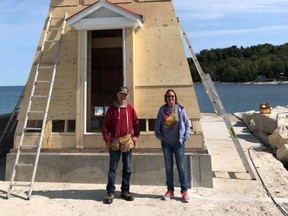 Doug Hill, left and Marydale Ashcroft stand in front of the new Lion's Head lighthouse, which was lifted into place in sections Monday. Work to add siding and other finishing touches will continue on the structure. (Photo courtesy Marydale Ashcroft)