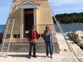 Doug Hill, left and Marydale Ashcroft stand in front of the new Lion's Head lighthouse, which was lifted into place in sections Monday. Work to add siding and other finishing touches will continue on the structure.
(Photo courtesy Marydale Ashcroft)